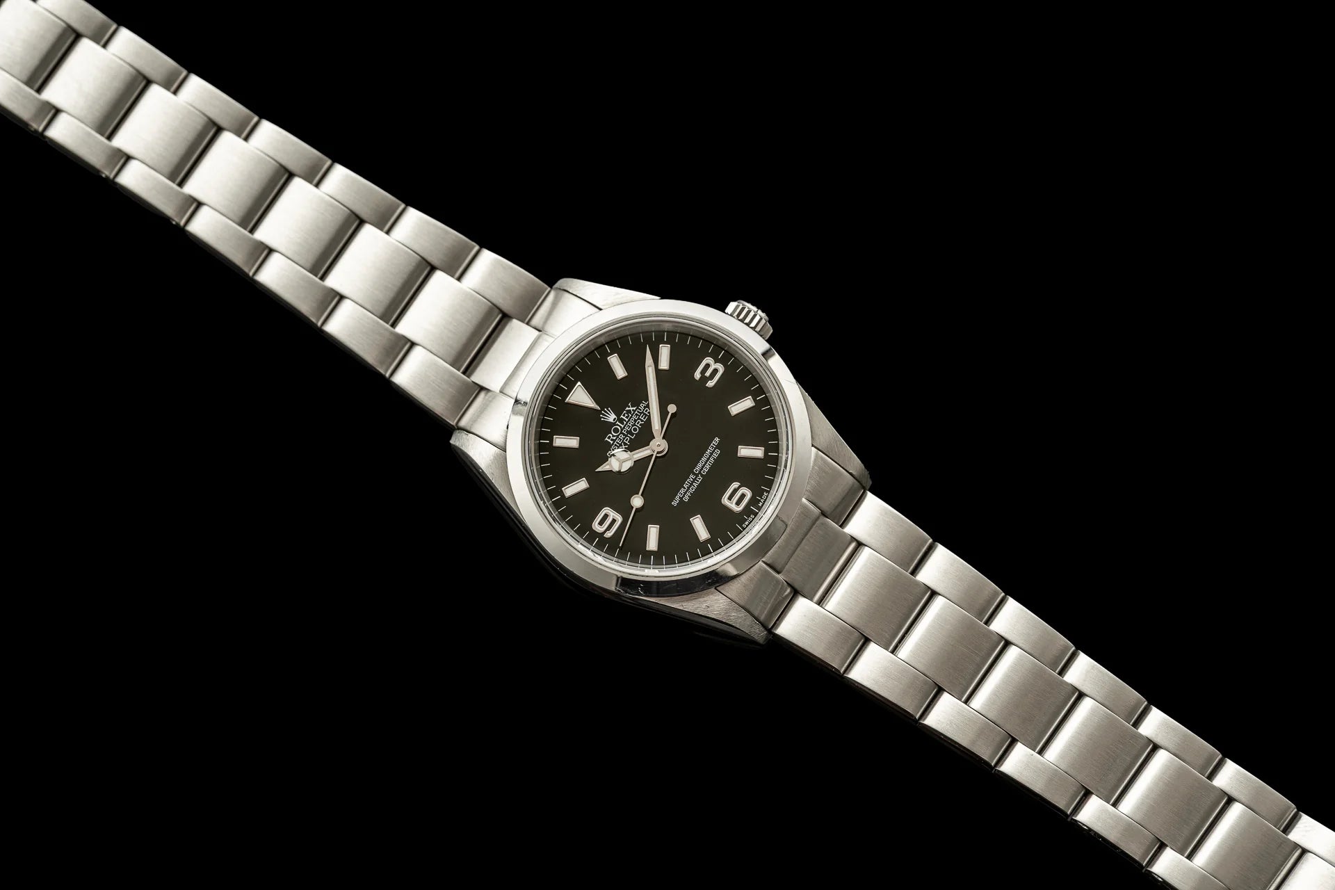 Stainless steel bracelet with solid links for Rolex Explorer 114270 watch on black background