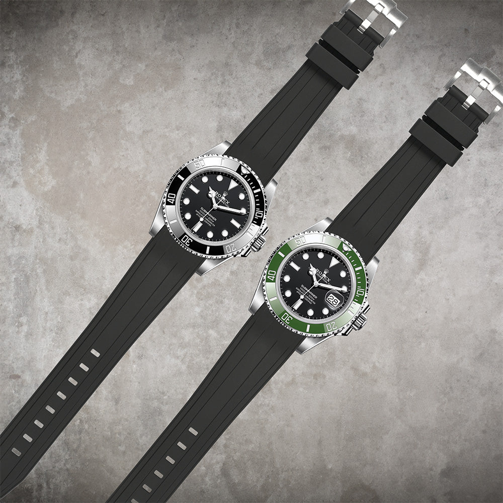 Two luxury dive watches with black dials on curved 21mm vulcanised rubber straps, one with black bezel and one with green bezel