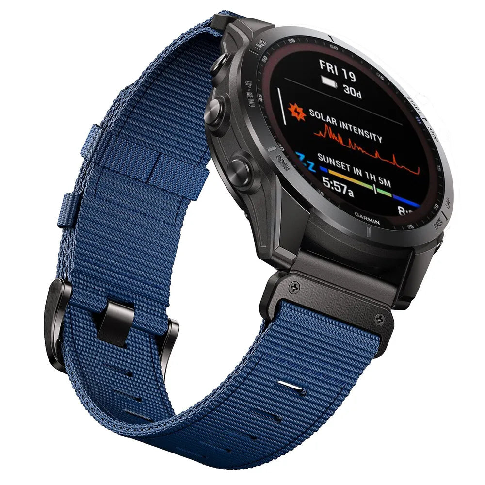 Garmin smartwatch with blue fabric military-style QuickFit band displaying solar intensity and sunset data on AMOLED screen