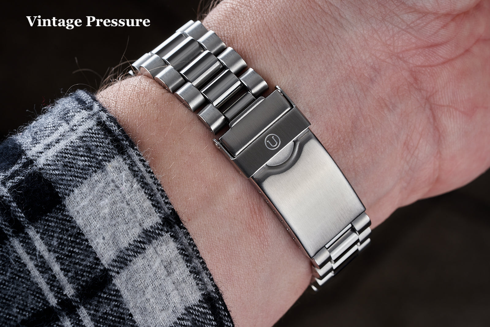 Vintage Pressure stainless steel Uncle Lincoln bracelet on wrist with black and silver two-tone metal links and push-button clasp
