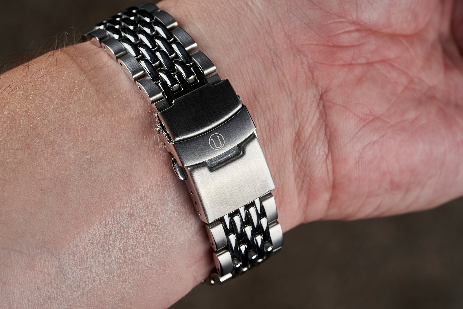 Stainless steel beads of rice bracelet with deployant clasp worn on wrist, compatible with Seiko SKX013 dive watch