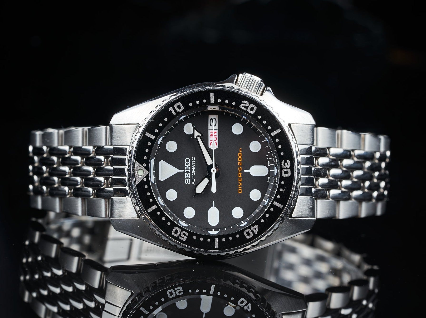 Seiko Diver's 300m automatic watch with black dial, white hour markers, steel bracelet and rotating bezel