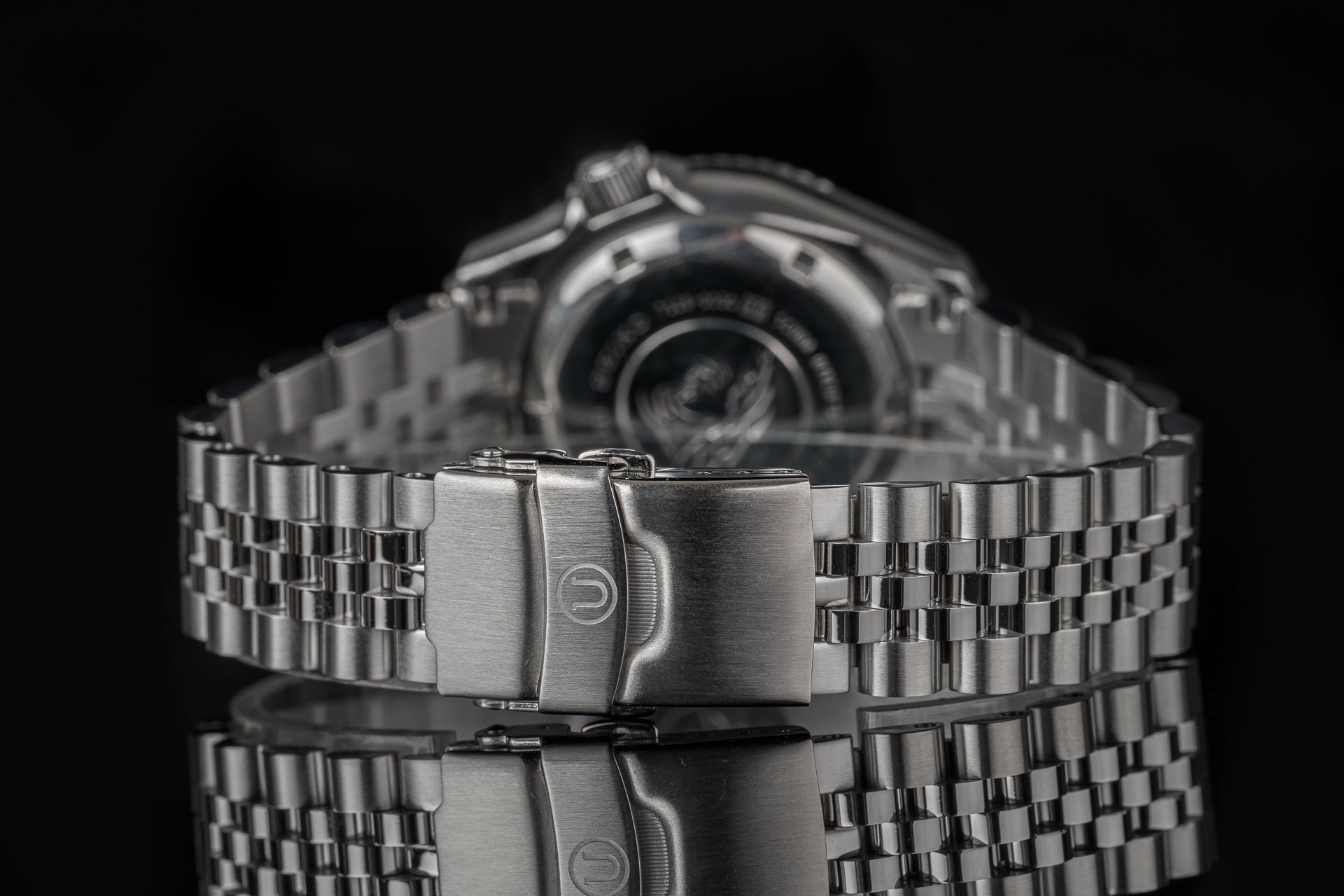 Stainless steel bracelet with fold-over clasp for Executive watch, featuring polished links and precision engineering in close-up detail