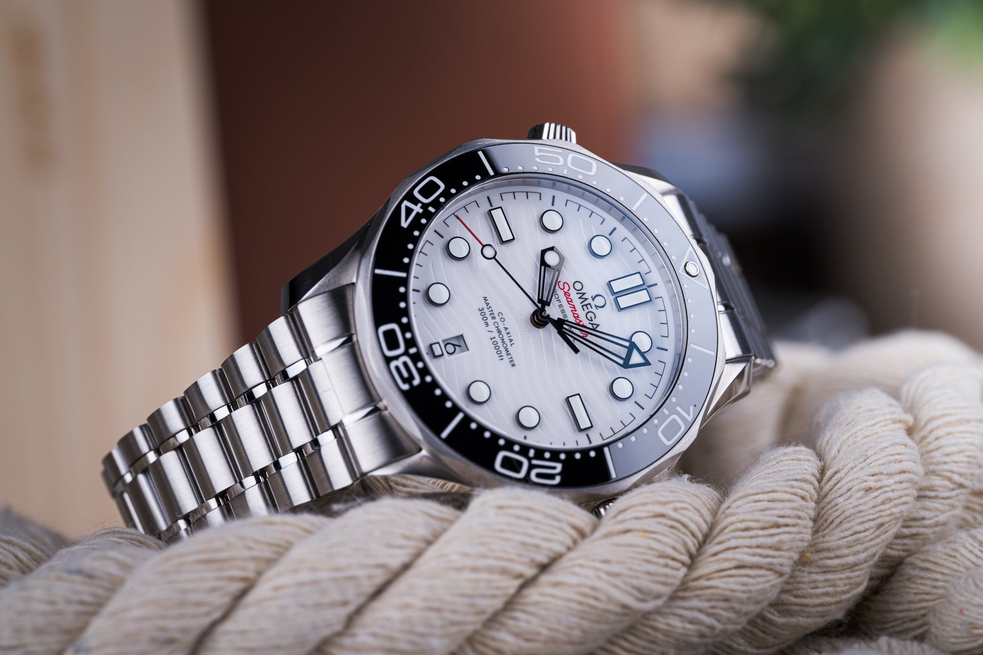 Omega Seamaster 300m professional dive watch with white dial, stainless steel bracelet and bezel on rope