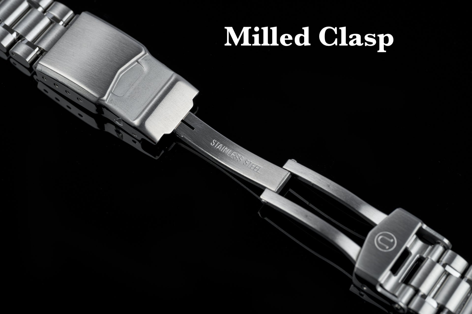 Stainless steel milled clasp watch bracelet with polished metal links and secure fastening mechanism on black background