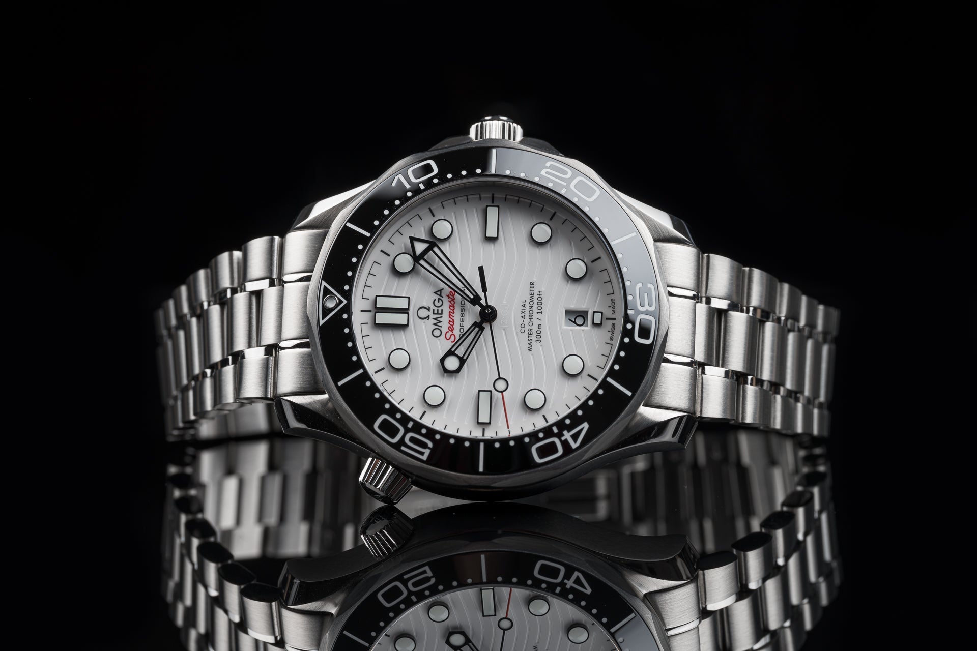 Omega Seamaster 300m stainless steel dive watch with white dial, black bezel, and matching bracelet