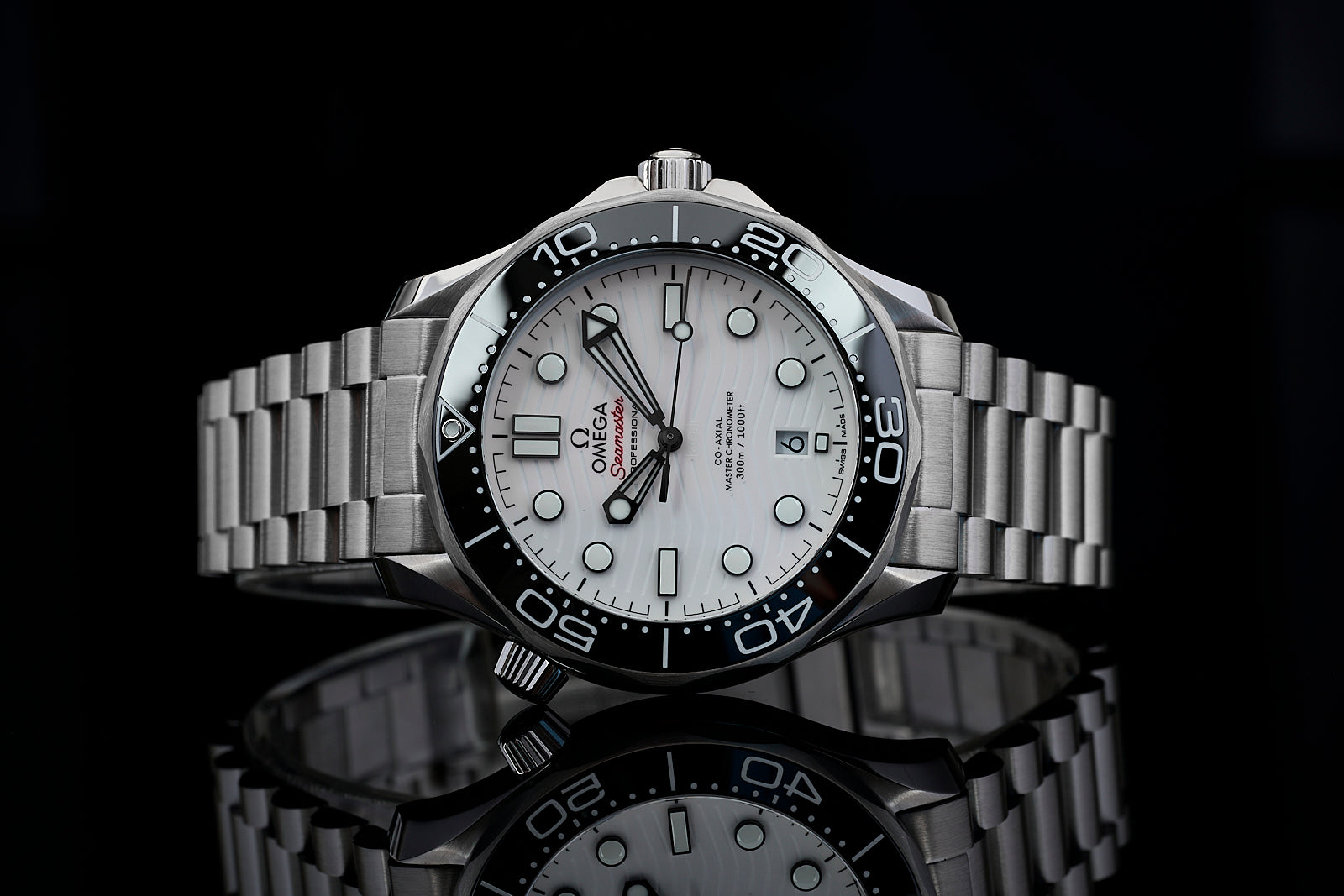 Omega Seamaster stainless steel dive watch with white dial, black bezel, and metal bracelet on black background