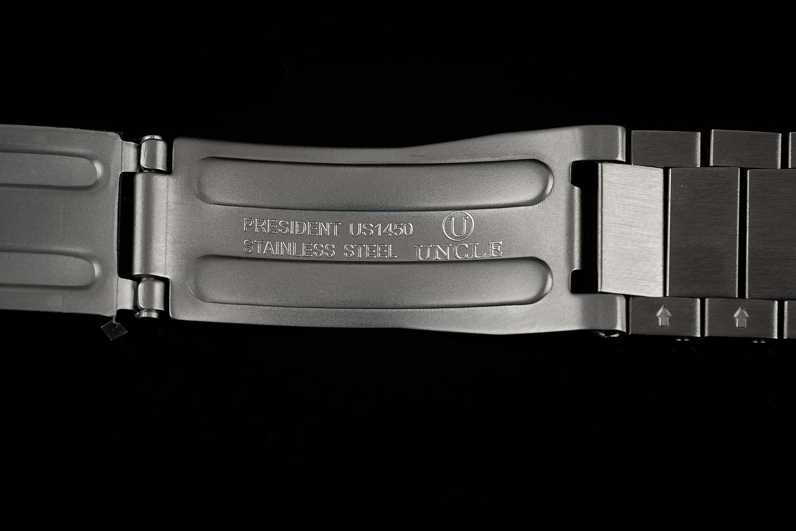 Stainless steel Uncle President US1450 watch bracelet with polished center links and brushed outer links on black background