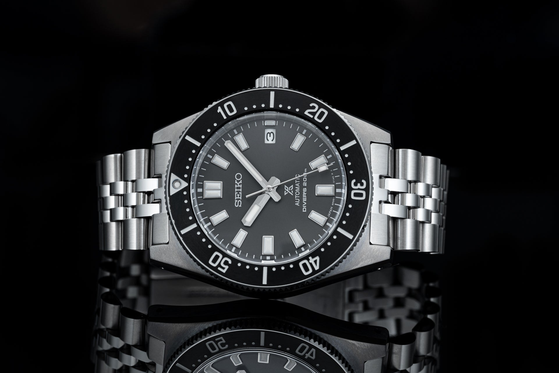 Seiko SPB147 62MAS reissue automatic dive watch with black dial, stainless steel bracelet and rotating bezel on black background