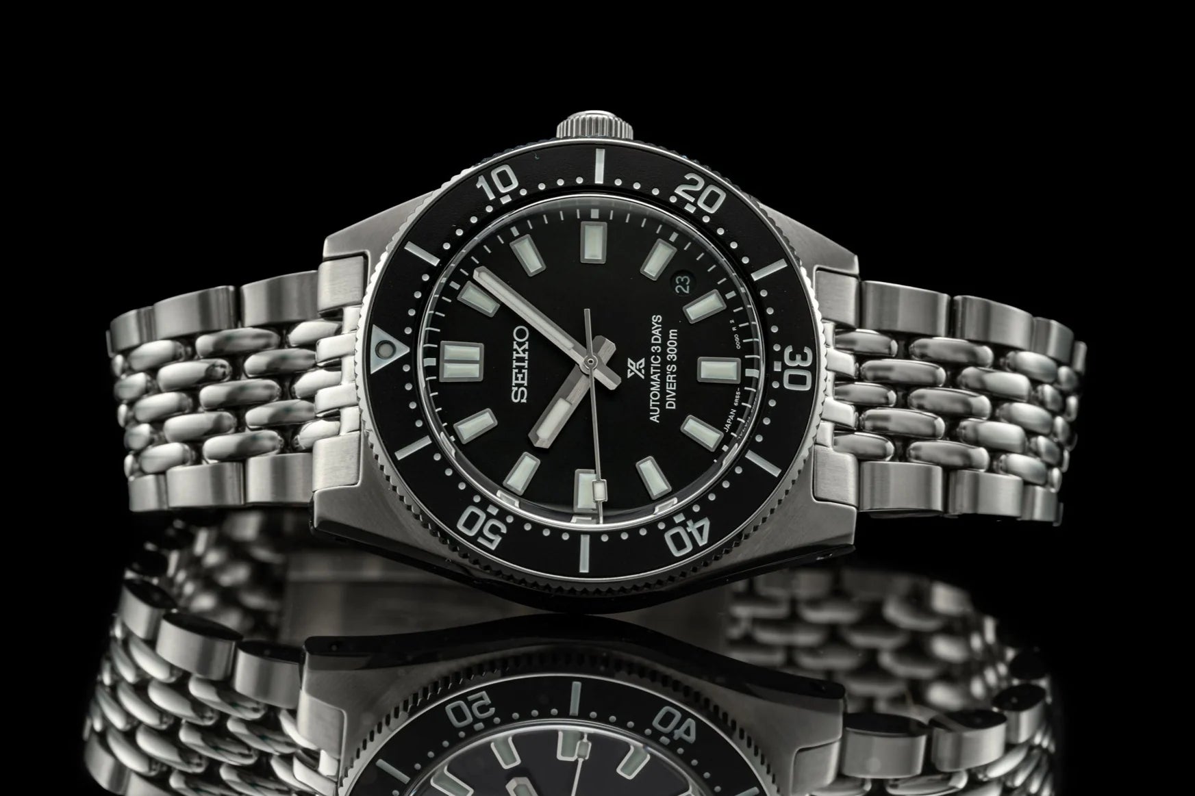 Seiko Prospex automatic dive watch with black dial, stainless steel beads of rice bracelet, and rotating bezel