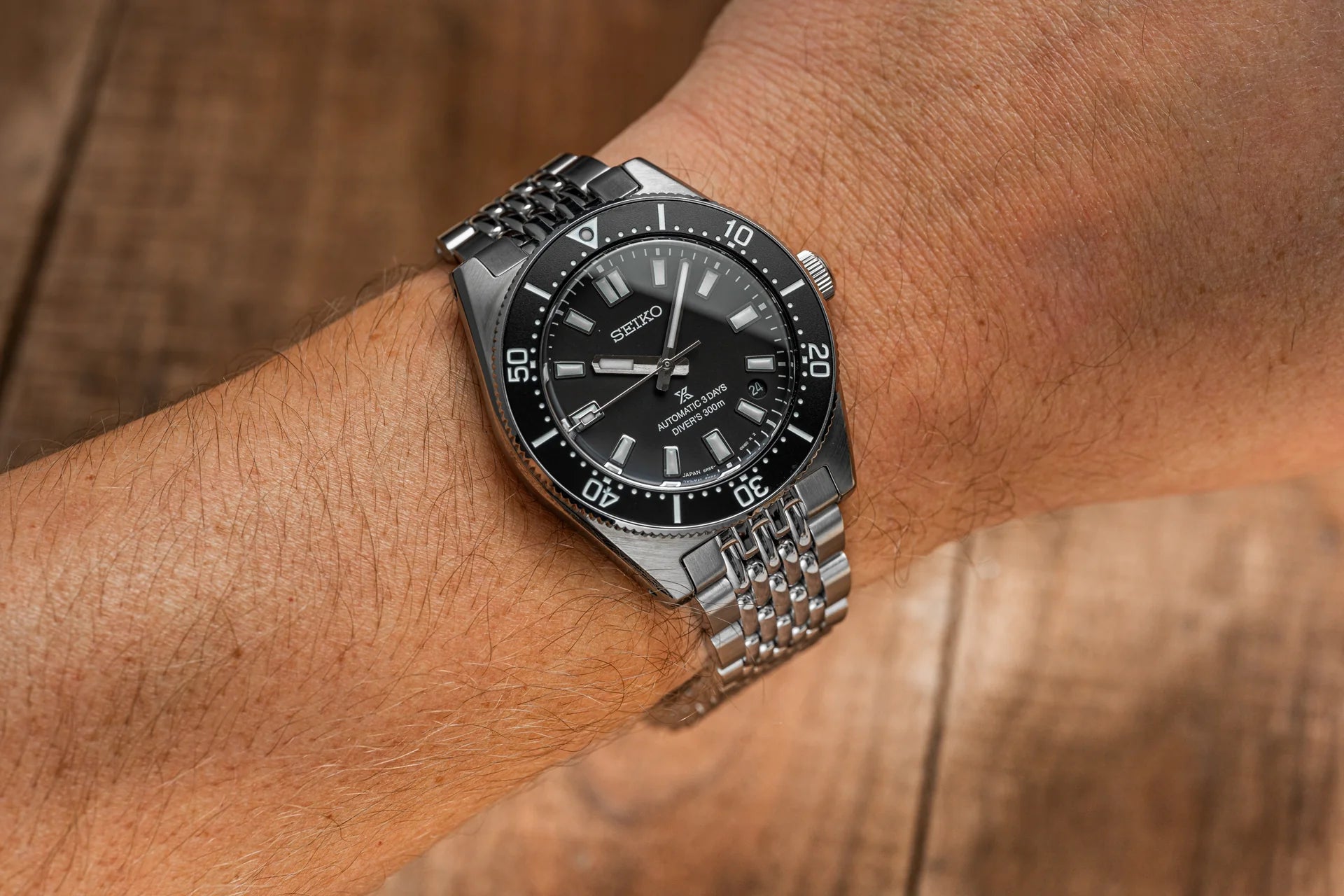 Seiko Prospex automatic dive watch with black dial and stainless steel Jubilee bracelet worn on wrist