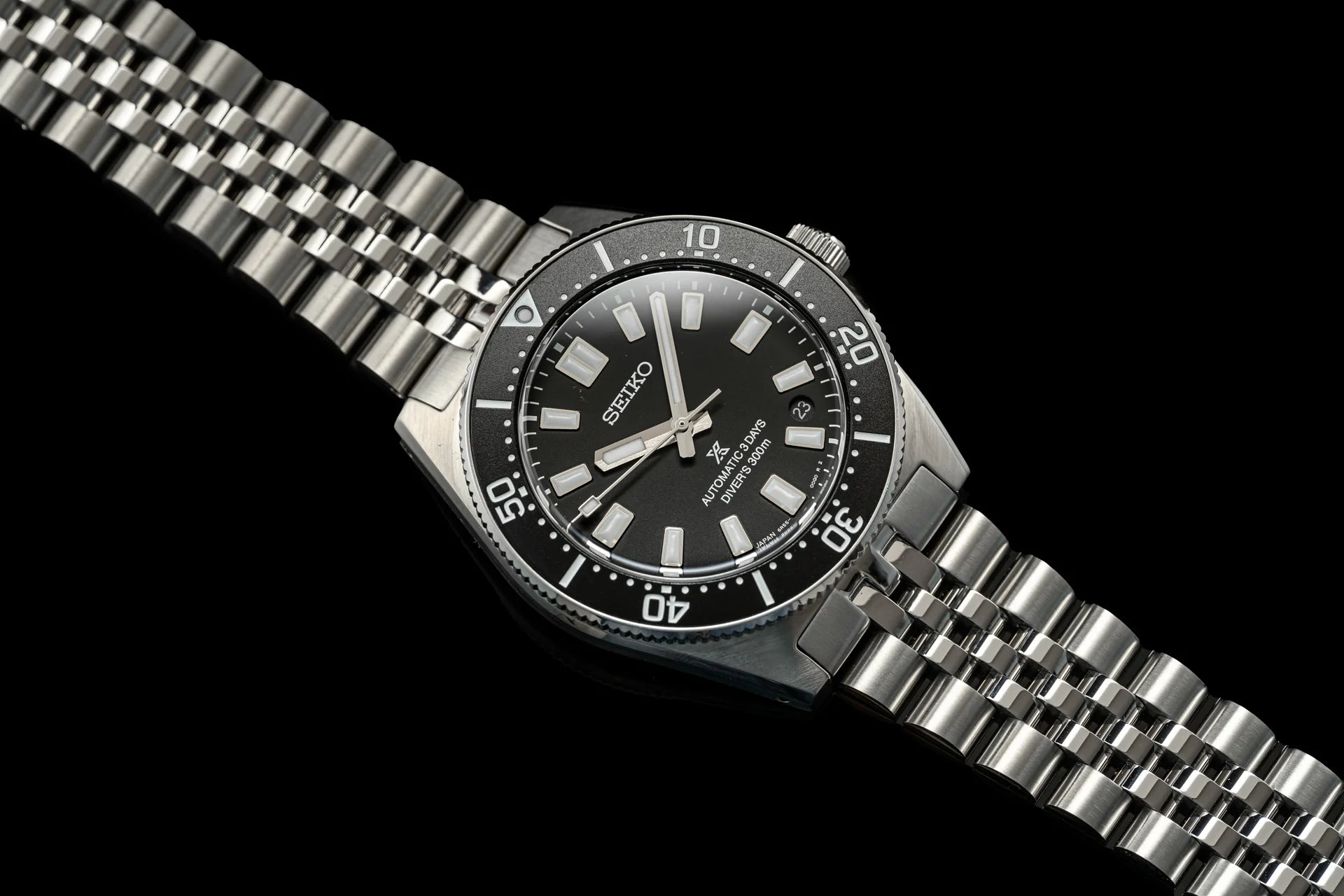 Seiko SPB45x automatic diver watch with black dial, stainless steel bracelet and rotating bezel on black background
