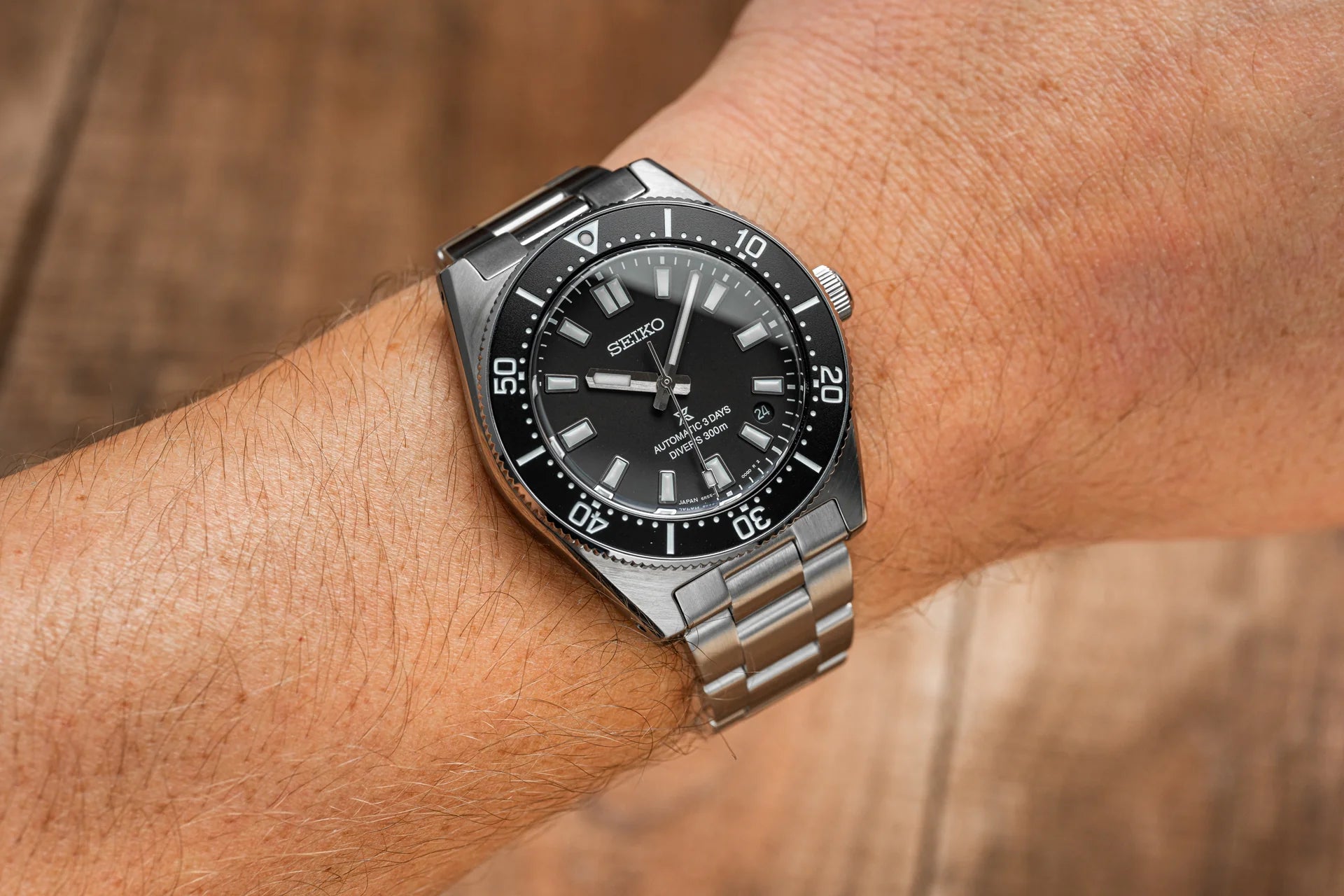 Seiko Prospex automatic dive watch with black dial, stainless steel bracelet and bezel, 300m water resistance, worn on wrist