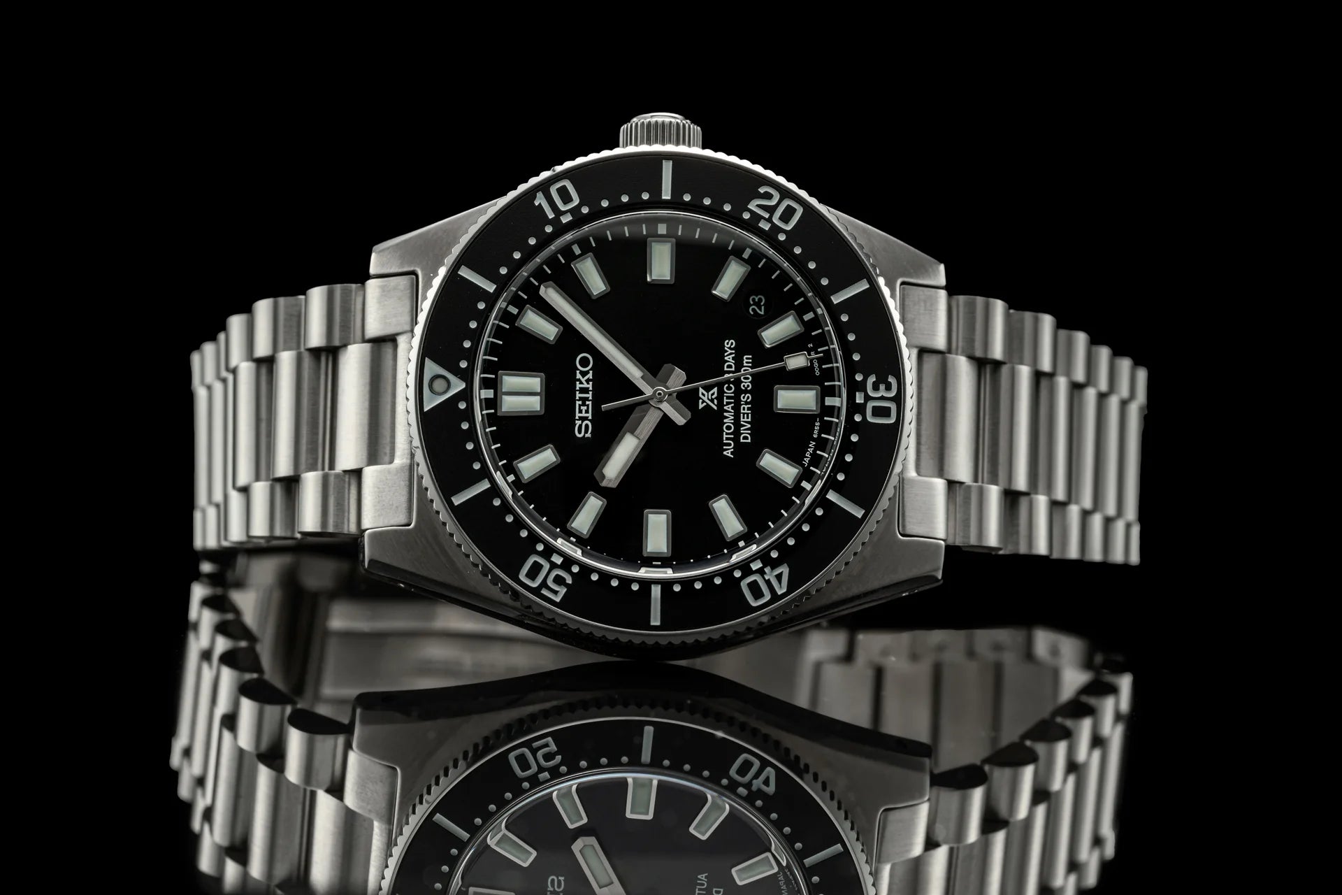 Seiko SPB45x automatic diver watch with stainless steel bracelet, black dial, and rotating bezel on black background