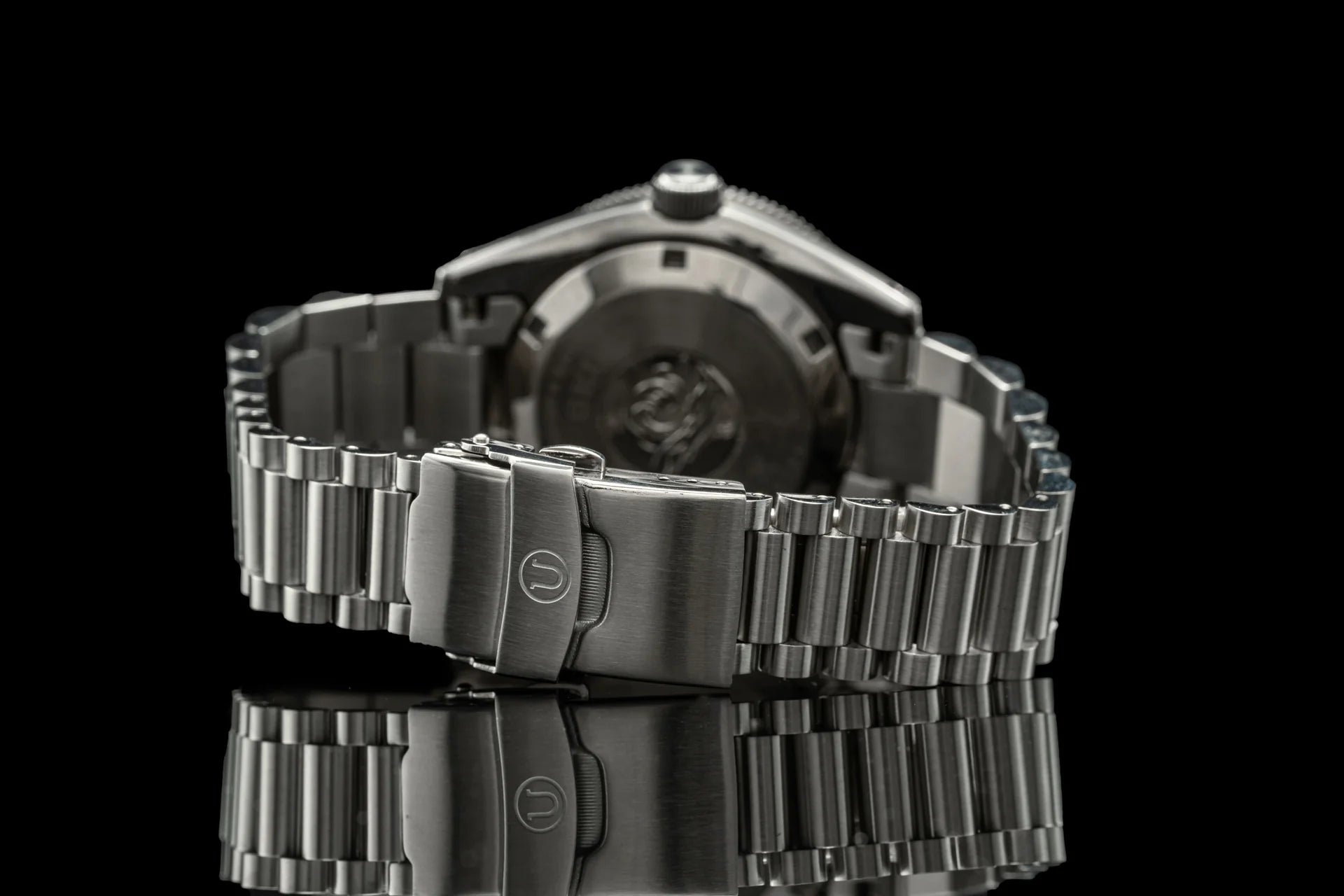 Stainless steel Lincoln bracelet watch with fold-over clasp, shown from side angle on black background