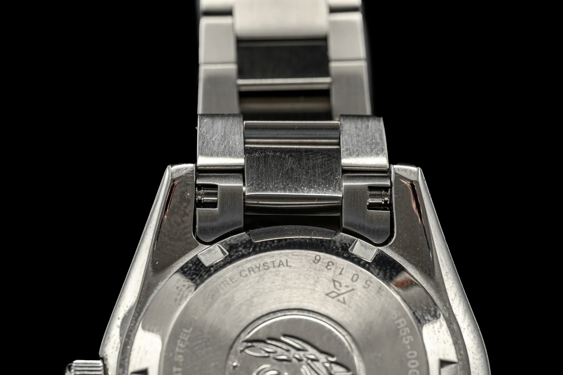 Stainless steel watch bracelet clasp and links for Seiko SPB45x dive watch showing sapphire crystal caseback