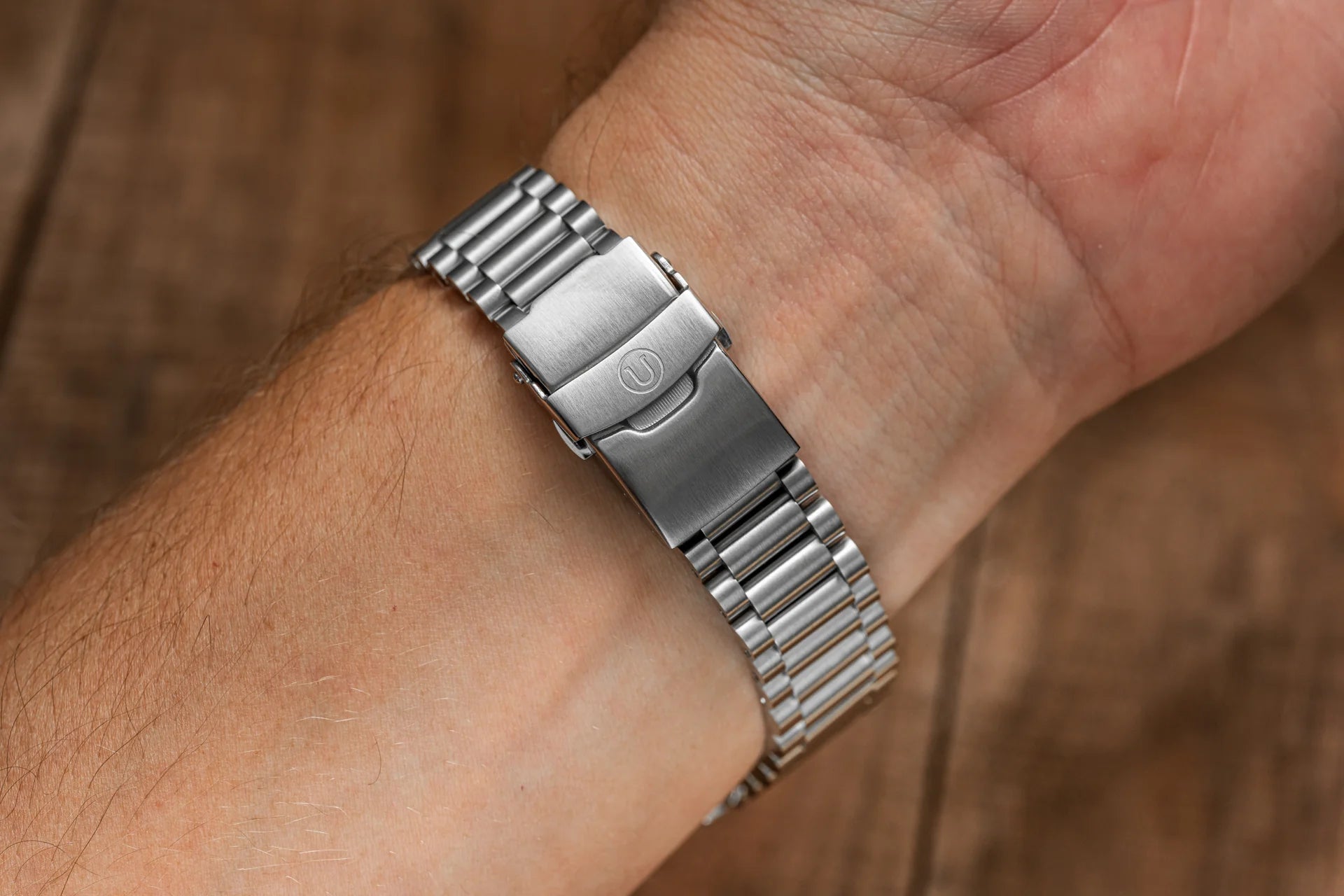 Stainless steel Uncle Lincoln bracelet with solid links and fold-over clasp fitted on men's wrist
