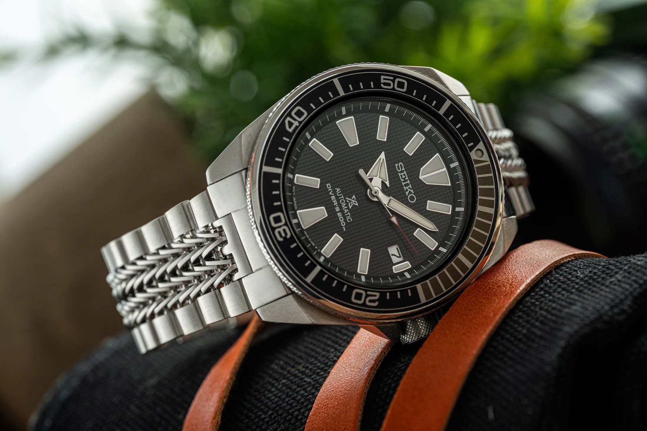 Seiko Samurai automatic dive watch with steel bracelet and black dial on brown leather strap