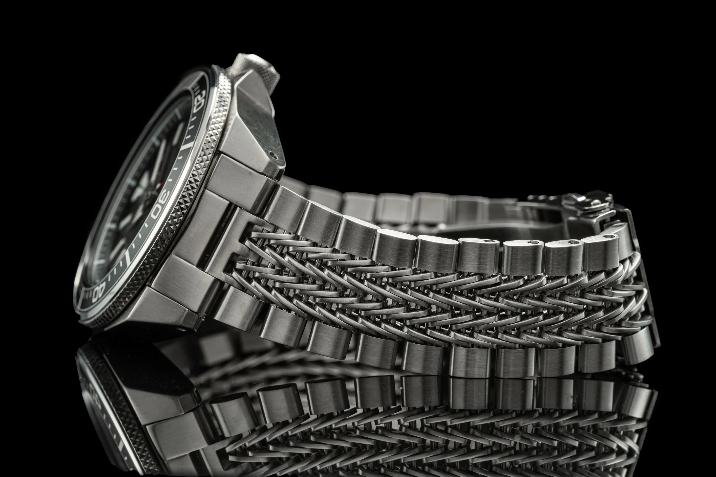 Stainless steel watch with razor-wire textured bracelet and circular dial, displayed on black background