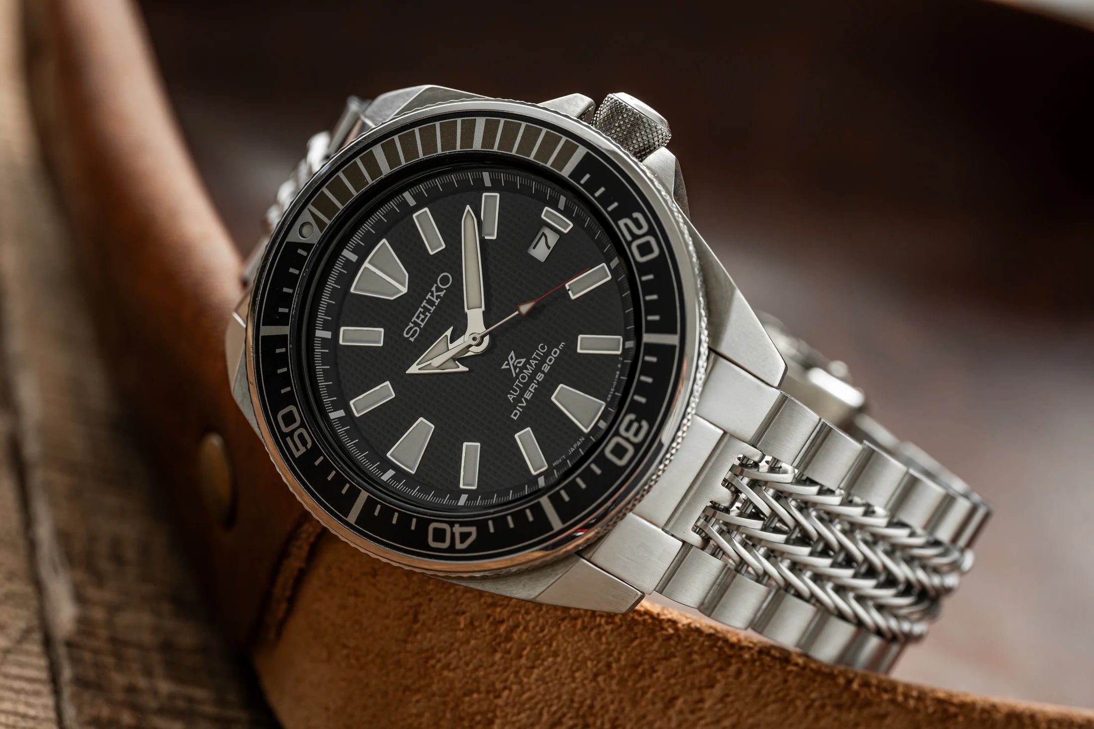 Seiko Samurai automatic dive watch with black dial, stainless steel bracelet, and luminous markers on wrist