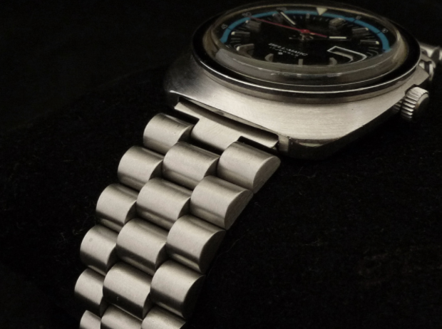 Vintage Seiko Bell-Matic 4006 stainless steel watch with black dial and blue accents on matching metal bracelet