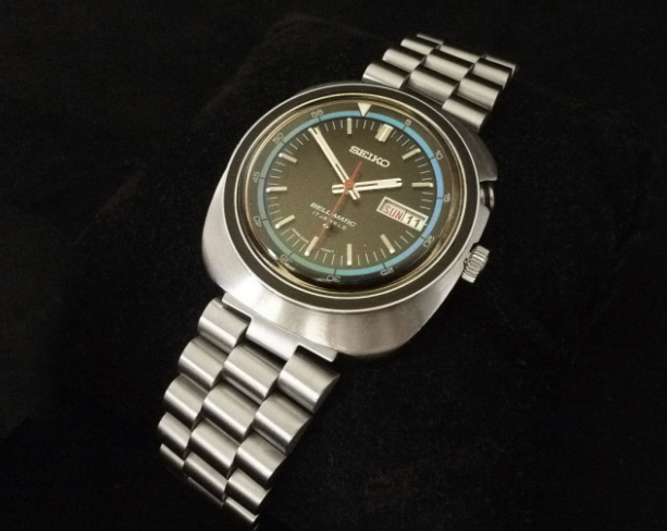 Vintage Seiko Bell-Matic 4006 automatic watch with steel bracelet and gray dial on black background