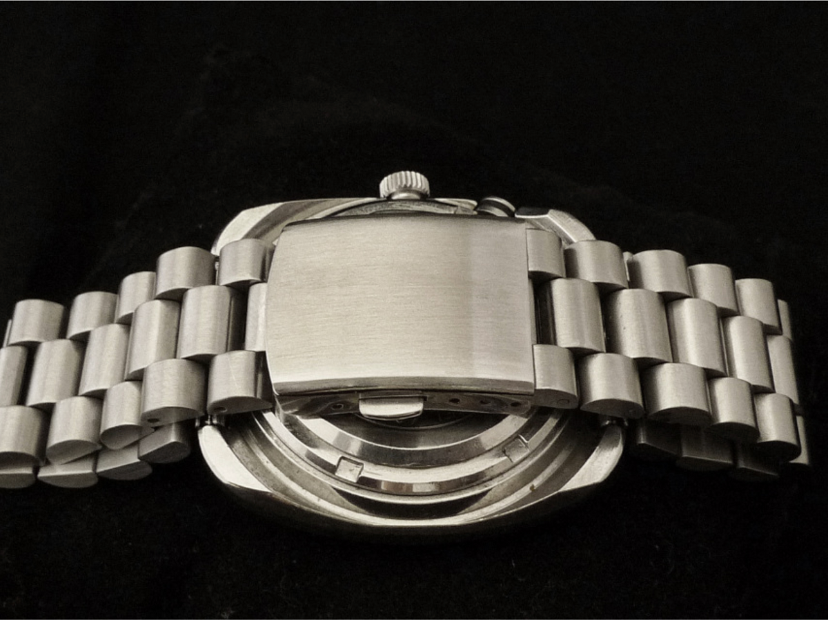 Stainless steel Seiko Bell-Matic 4006 automatic watch with brushed dial and integrated bracelet on black background