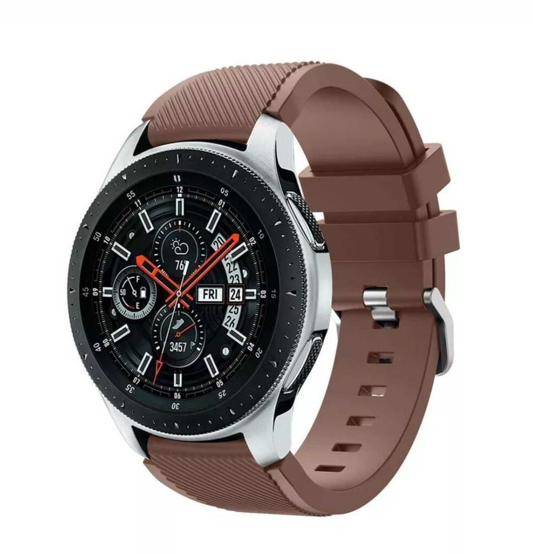 Brown silicone watch band with silver buckle for Fitbit Versa and Sense smartwatches, featuring flexible ribbed design and adjustable strap