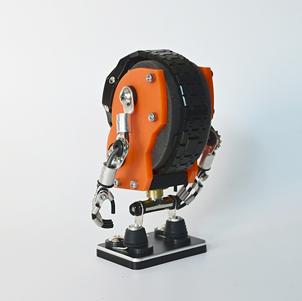 Orange and black robotic watch stand with articulated metal arms and base platform for displaying timepieces