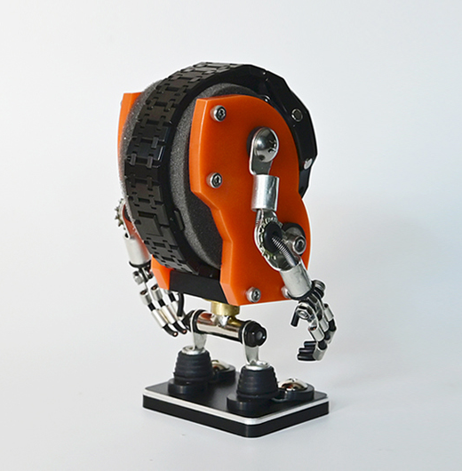 Orange and black robotic watch stand with articulated arms and legs on display base