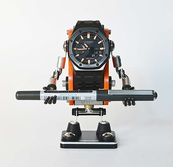 Orange and black minibot watch stand displaying analog digital sports watch with articulated arms and legs