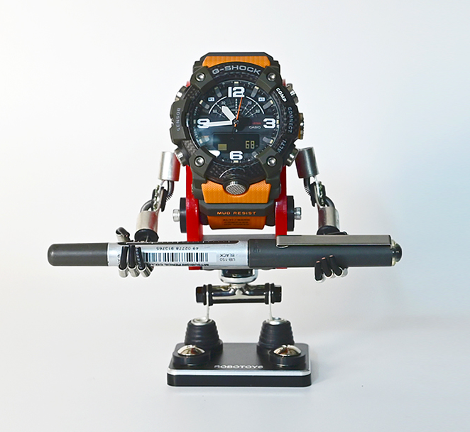 Red minibot watch stand with G-Shock digital sports watch displayed, featuring articulated arms and base