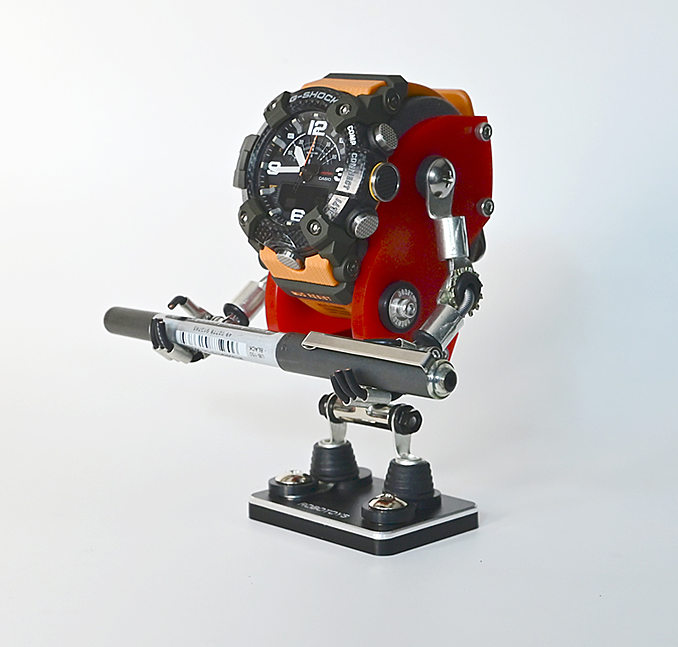 Minibot red robot watch stand with articulated arms holding digital chronograph watch and tactical gear display mount