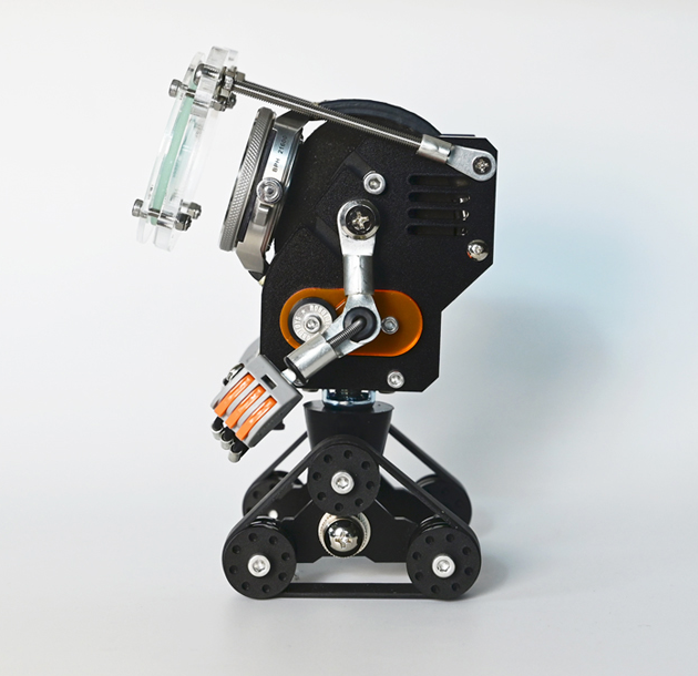 RoboTank black robotic watch stand with orange accent wheels and articulated mechanical arms holding clear display case