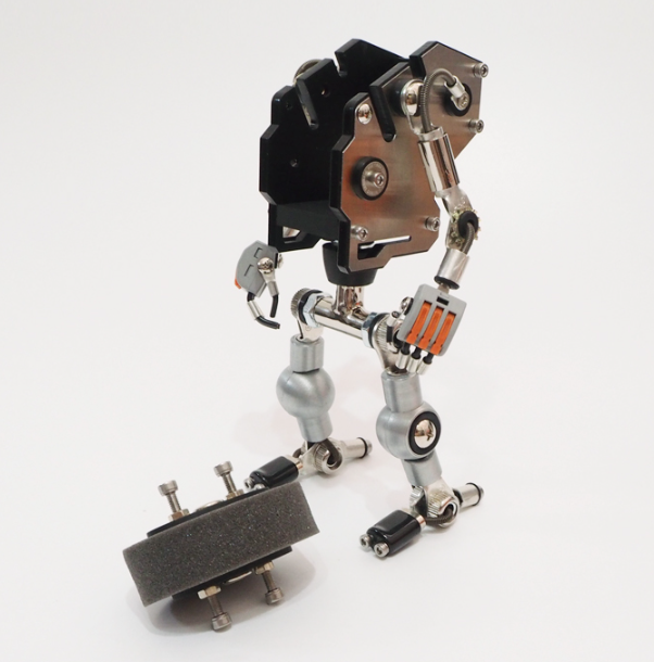 Steampunk RoboMech watch stand with articulated silver metal limbs, brown gear head, and orange accent details