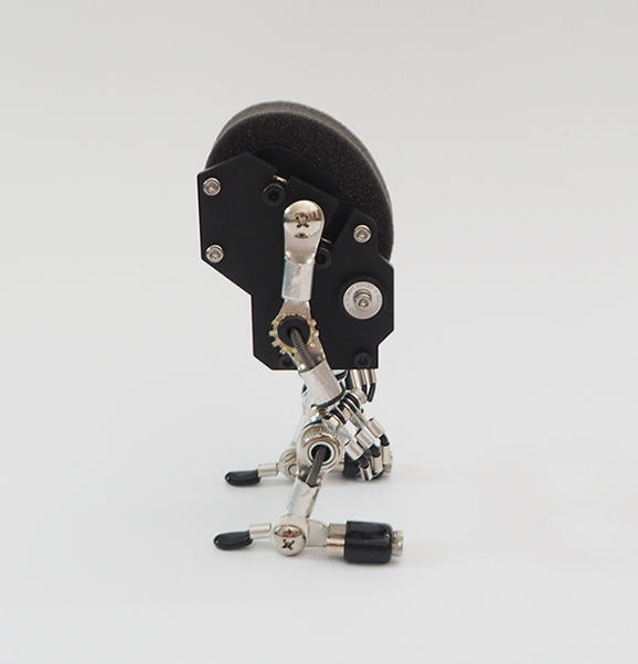 Black mechanical robot watch stand with articulated metal joints and silver hardware details