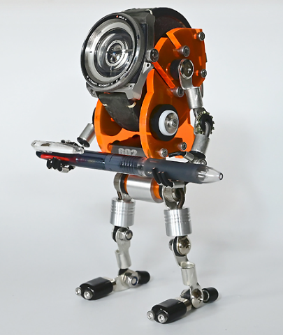 Orange robot watch stand with articulated silver metal legs and rotating torso mechanism, featuring black weapon accessory detail