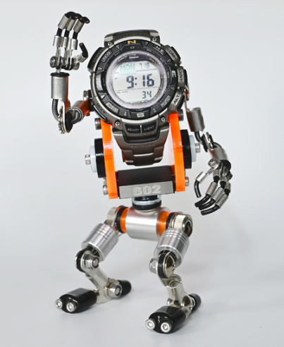 RoboMech orange and black transforming watch stand with articulated metal limbs and digital display watch head