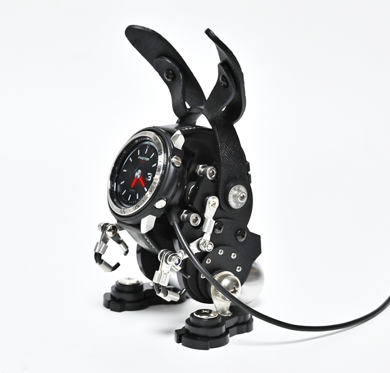 Black RoboRabbit watch stand with articulated rabbit ears, holding analog watch, metal hardware and suction cup base