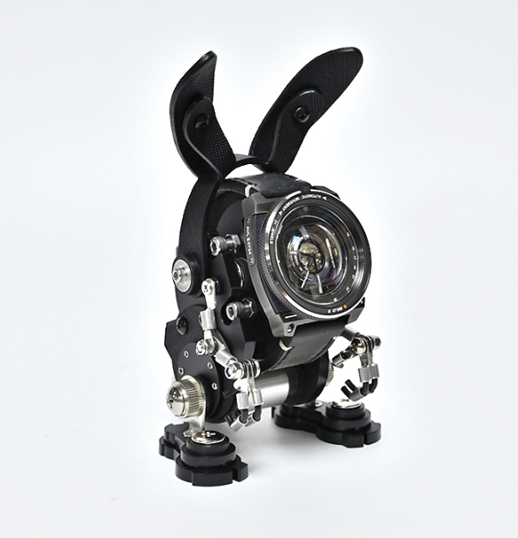 Black RoboRabbit mechanical watch stand with articulated ears and chrome accents holding analog timepiece