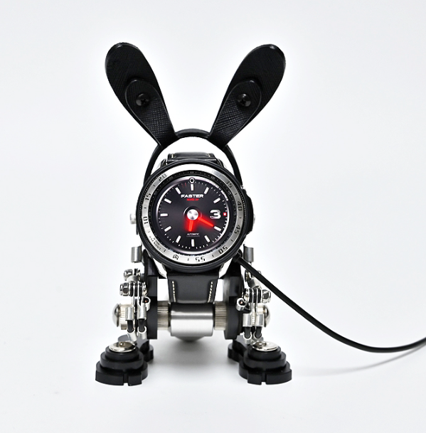 Black RoboRabbit watch stand with movable ears, metal legs, and analog timepiece display on white background