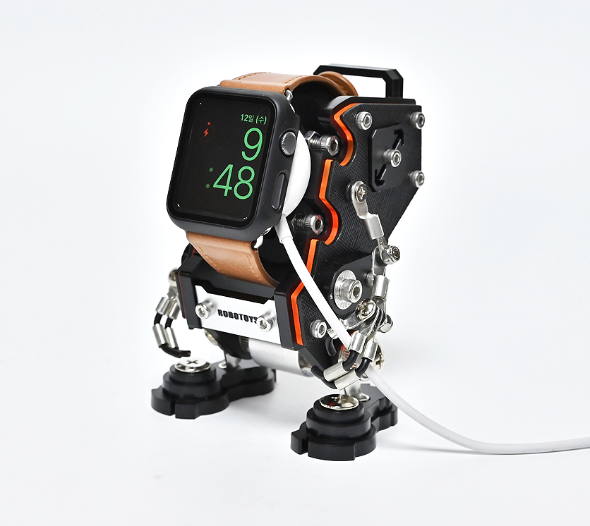 RoboToys NanoBot smartwatch stand with black and orange robotic design, tan leather strap and metal joints
