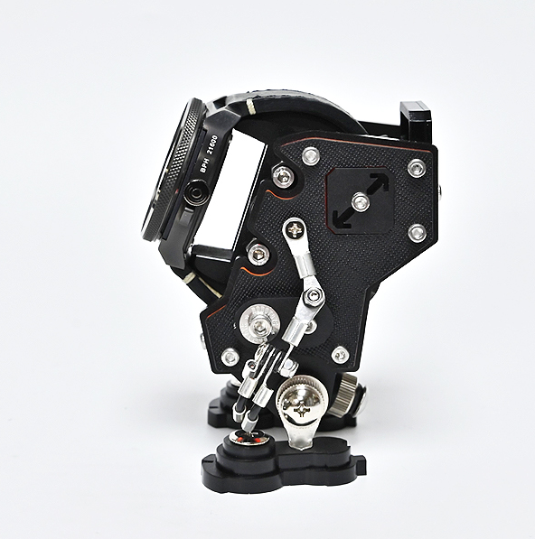 Black tactical watch stand with mechanical details and metal accents, displaying compact timepiece holder with industrial design