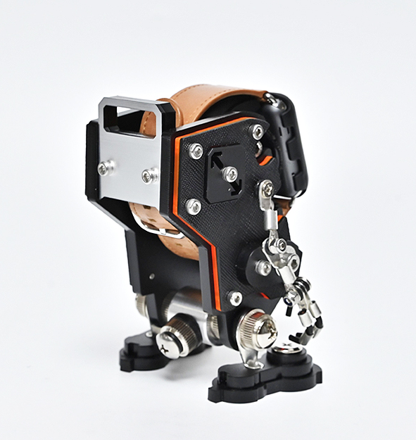 Black and tan mechanical NanoBot watch stand with exposed gears, metal joints, and articulated limbs on white background