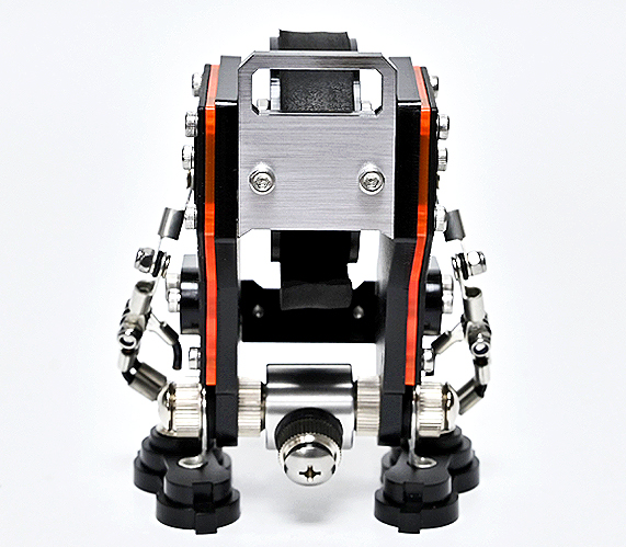 RoboToys NanoBot watch stand in saffiano black with red and silver details, overhead view showing articulated robot design and watch holder compartment