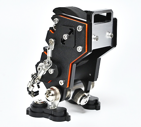 Black and orange NanoBot robotic watch stand with articulated arms and mechanical details on white background