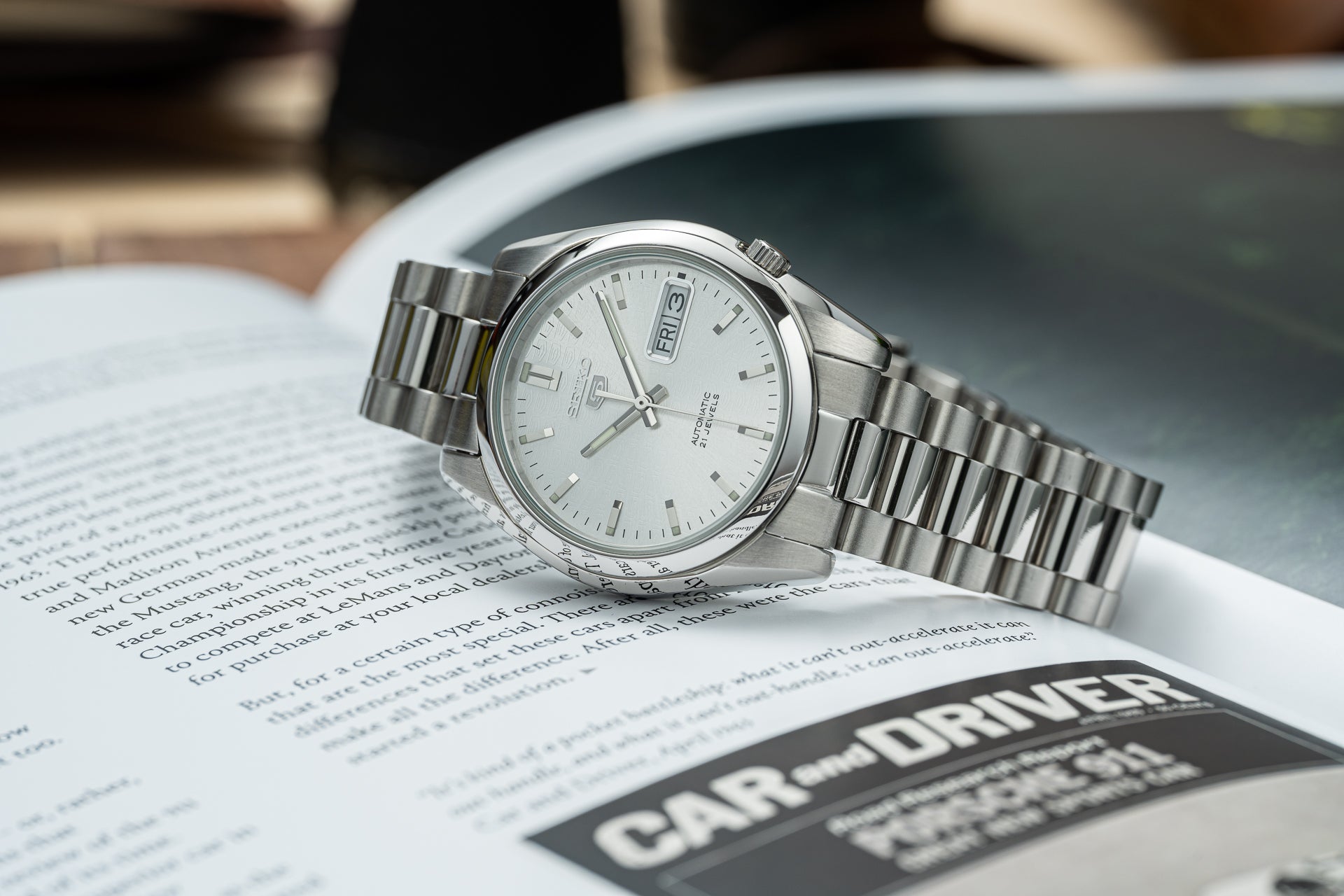 Seiko 5 SNKL stainless steel automatic watch with silver dial and day-date window on bracelet band