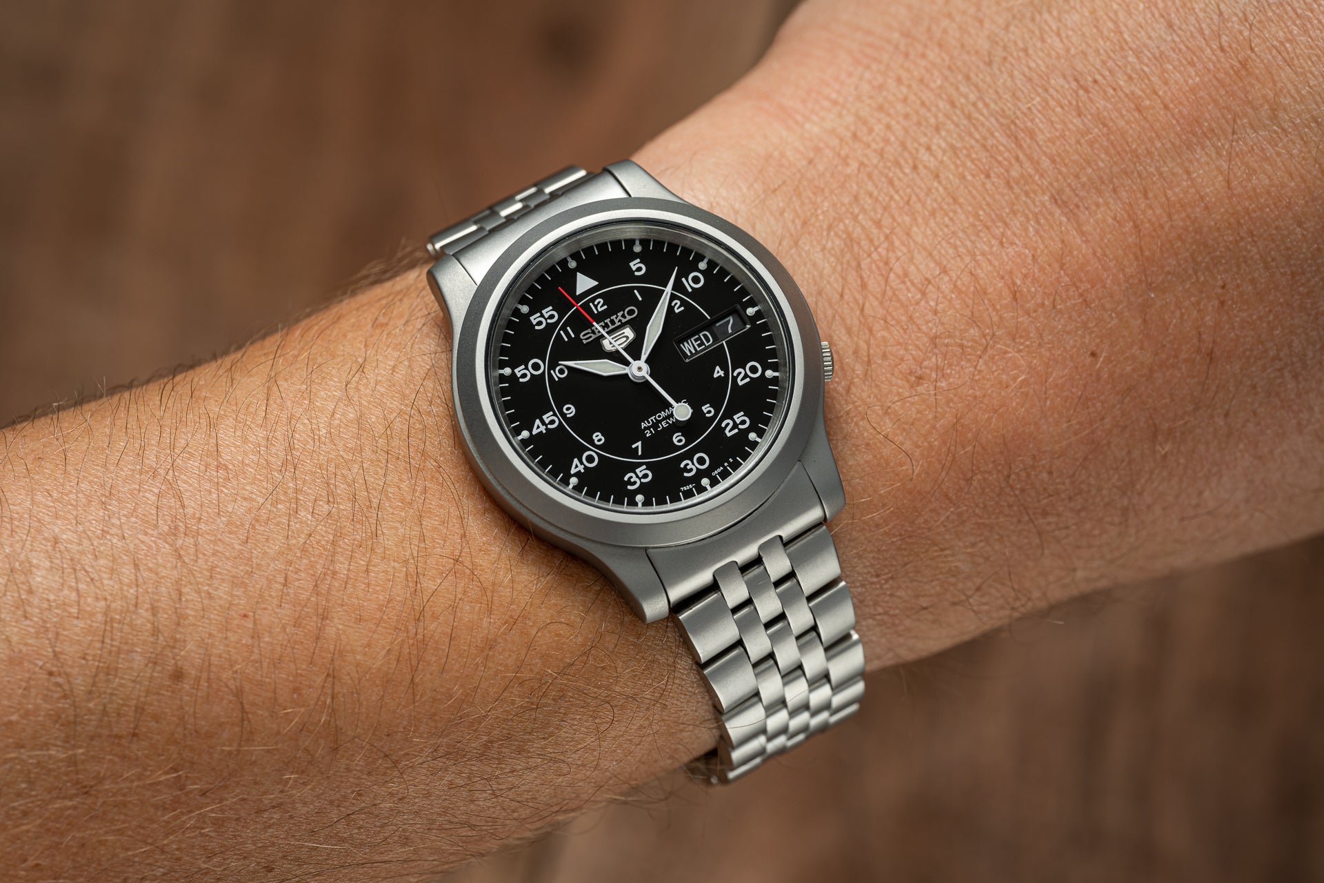 Seiko SNK809 automatic stainless steel watch with black dial and day-date window on metal bracelet