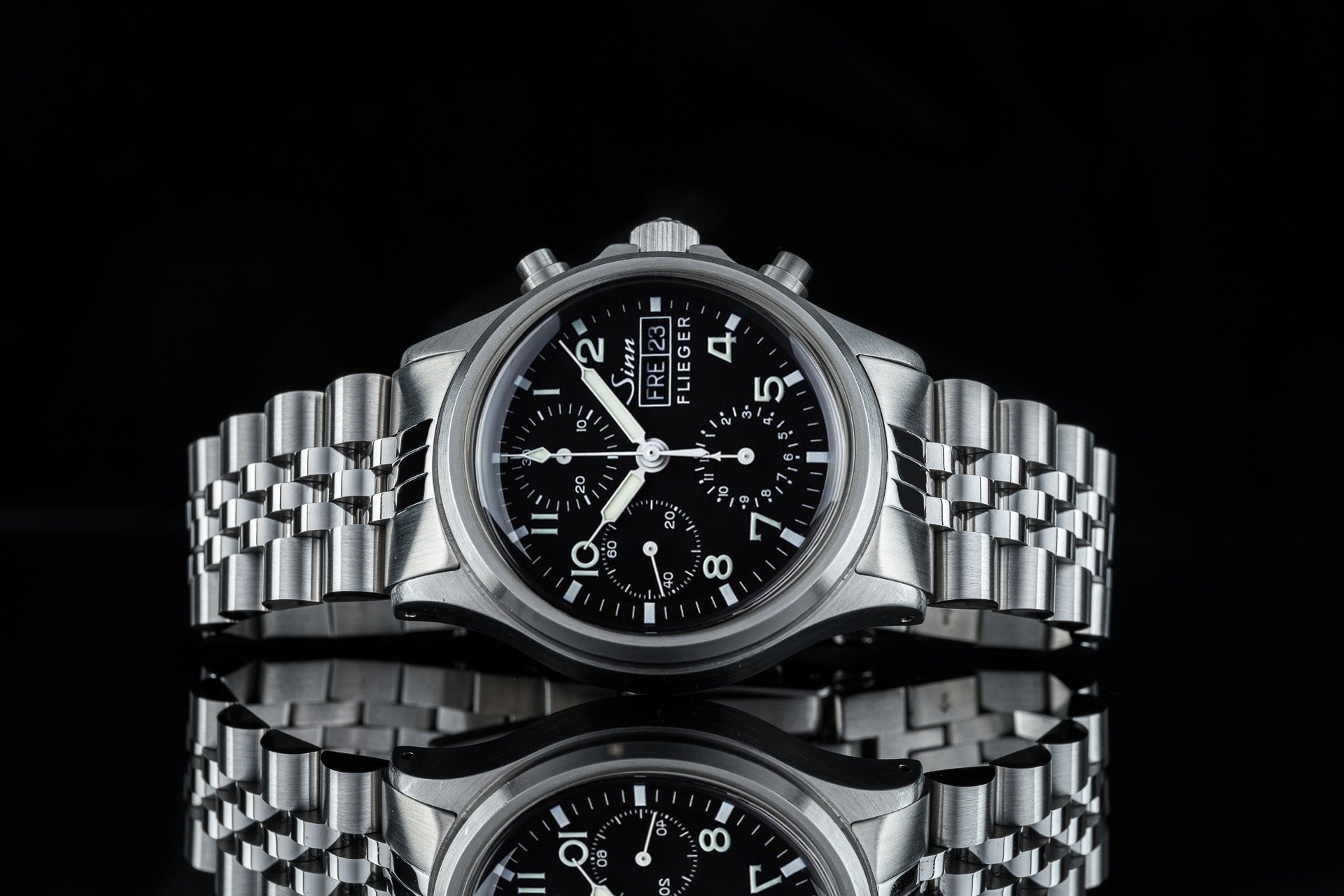 Sinn Flieger 356 chronograph watch with black dial, stainless steel bracelet and case, professional pilot watch with subdials on black background