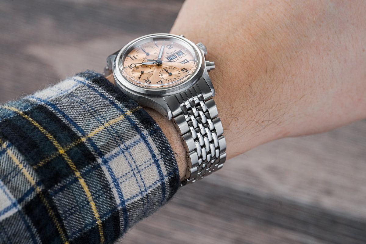 Stainless steel Sinn Flieger 356 chronograph watch with beads of rice bracelet on wrist, champagne dial with subdials